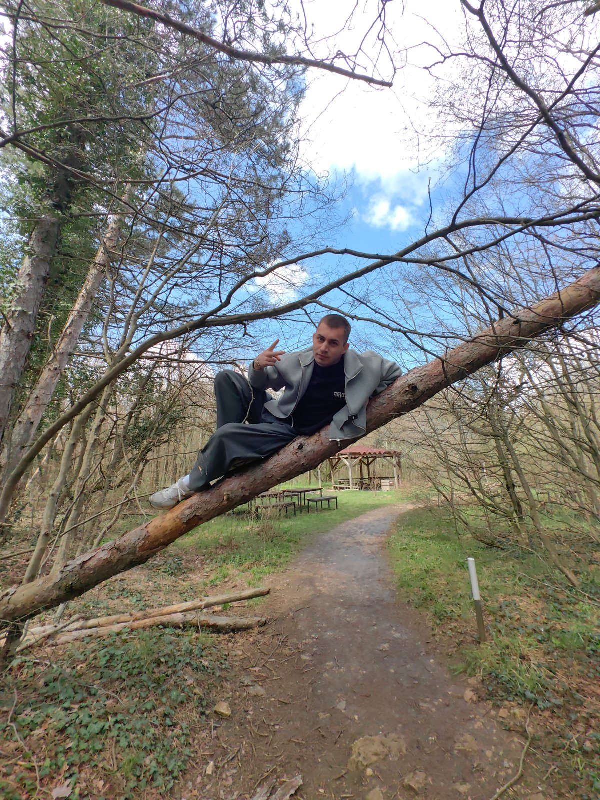 Man performs jumping poses at Shumen landmarks