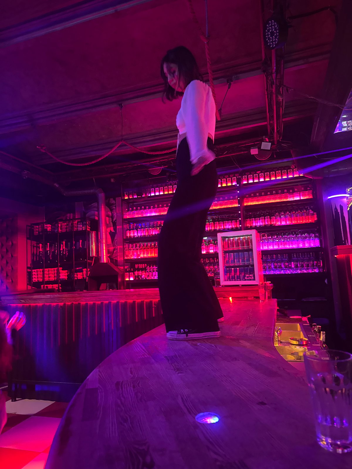 Late-night dancing at a neon-lit bar in Perm, Russia