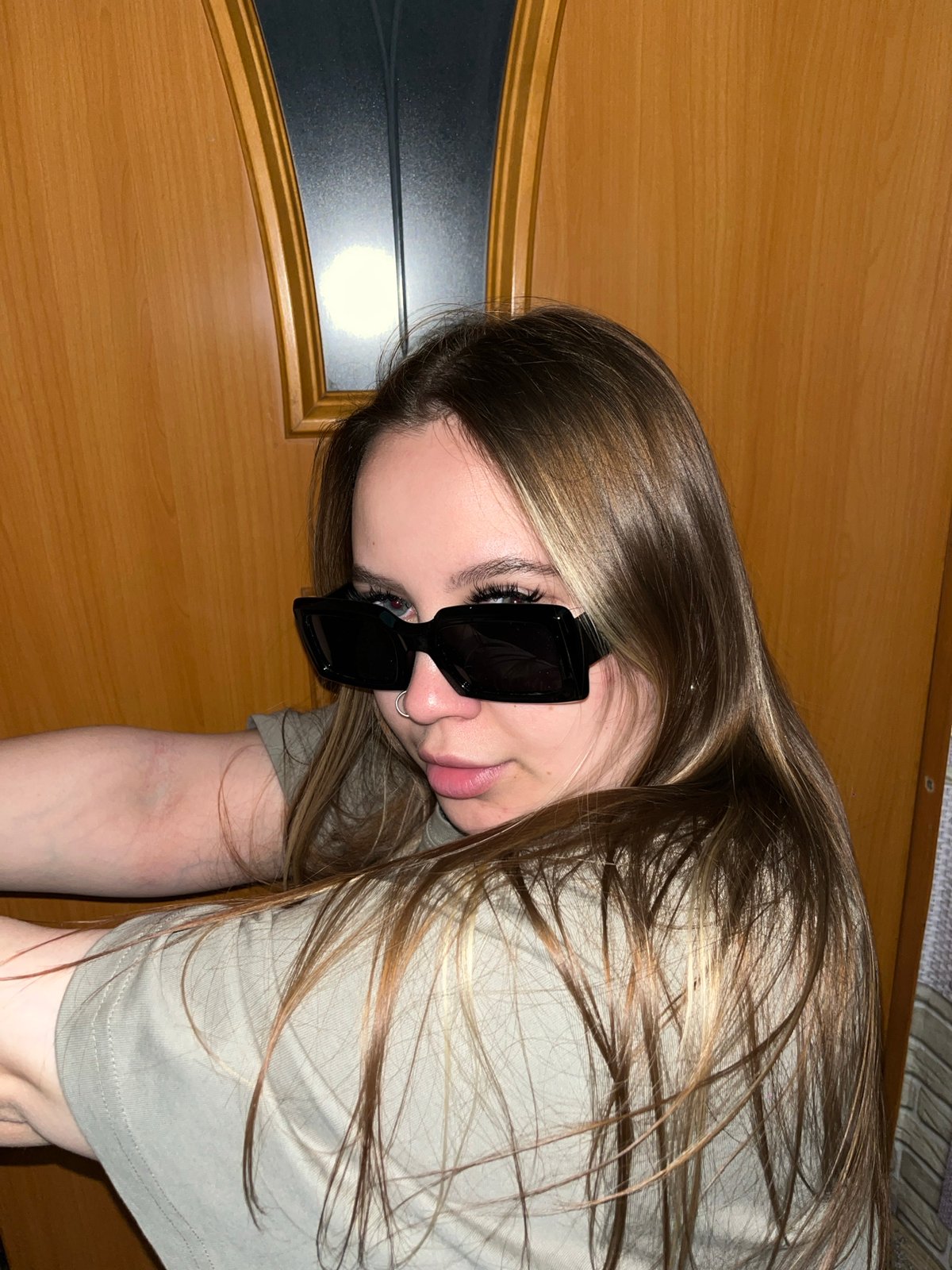 Young woman photographed in casual indoor poses in Port-Katon