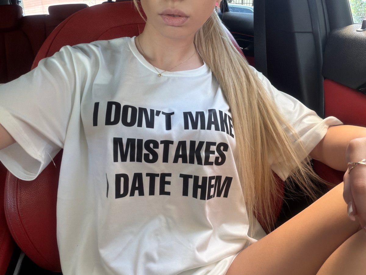 Woman in humorous t-shirt spotted in car passenger seat