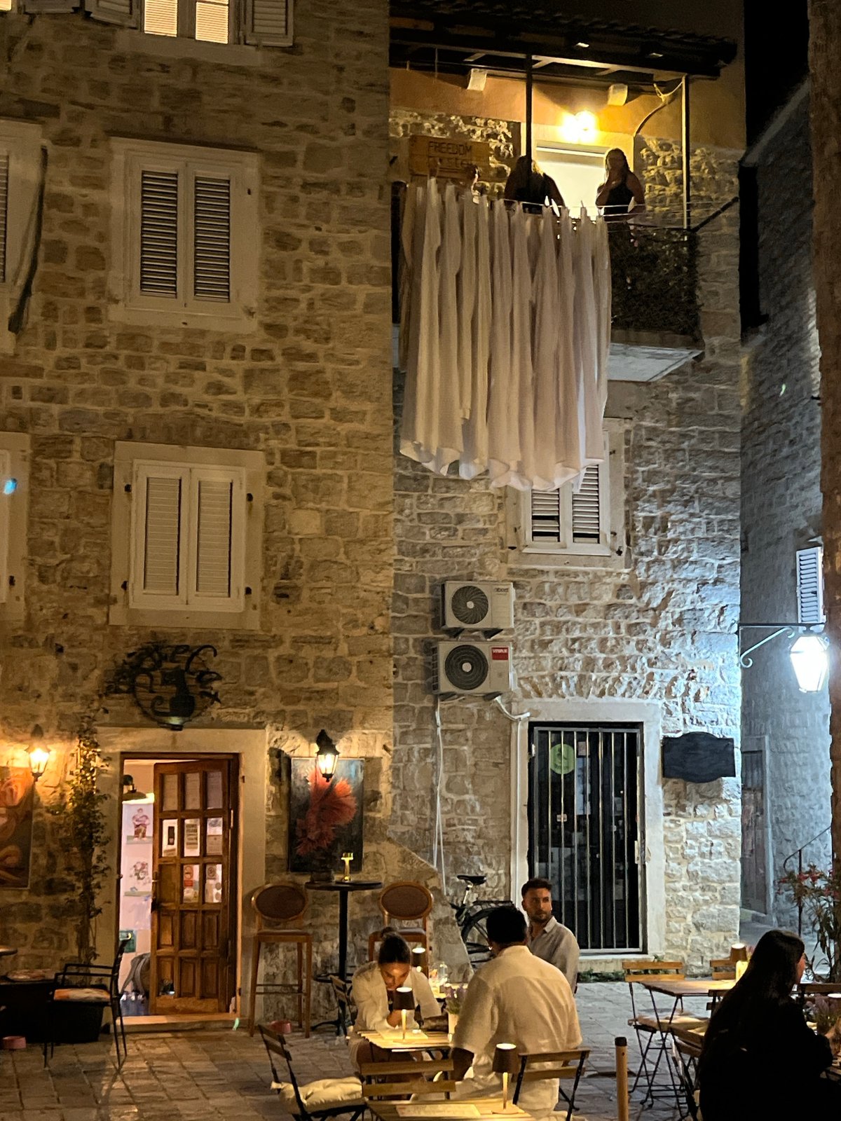 Late-night scenes from Budva's Old Town, cat included