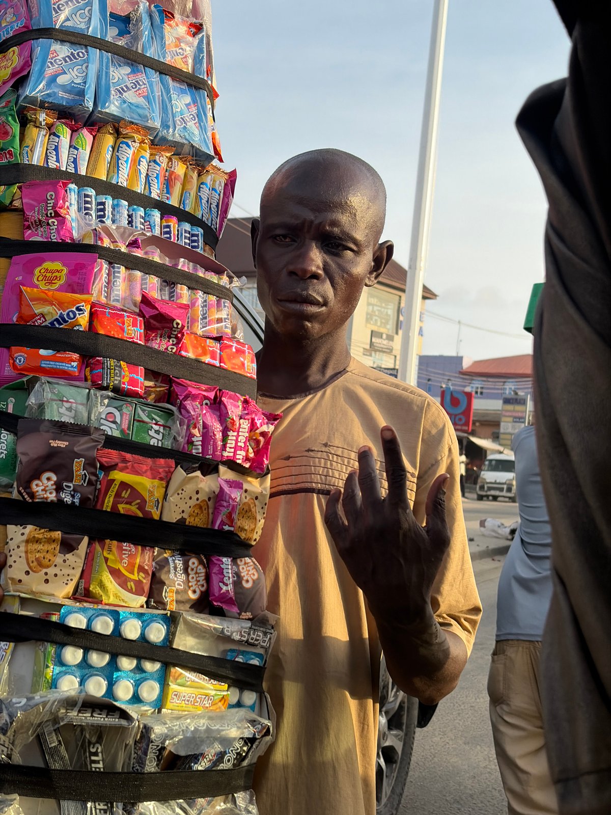 Mobile vendor sells candy, snacks on streets in Ado, Nigeria