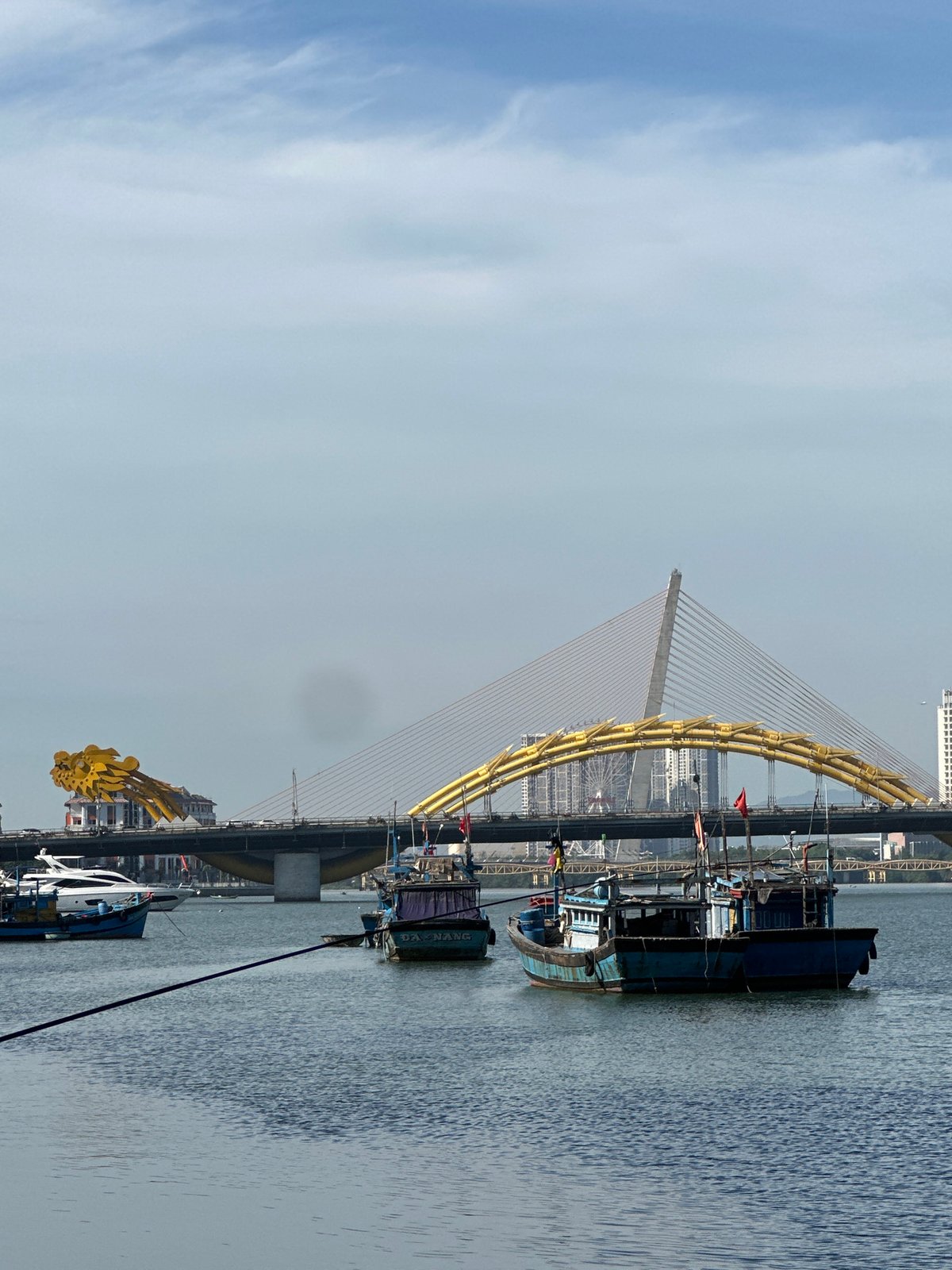 Han River waterfront life in Da Nang, Dragon Bridge in view