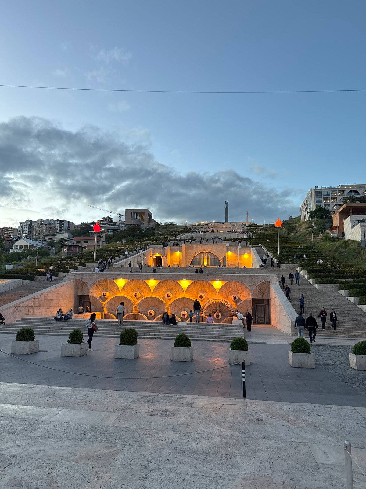 Evening visitors gather at illuminated Yerevan Cascade complex