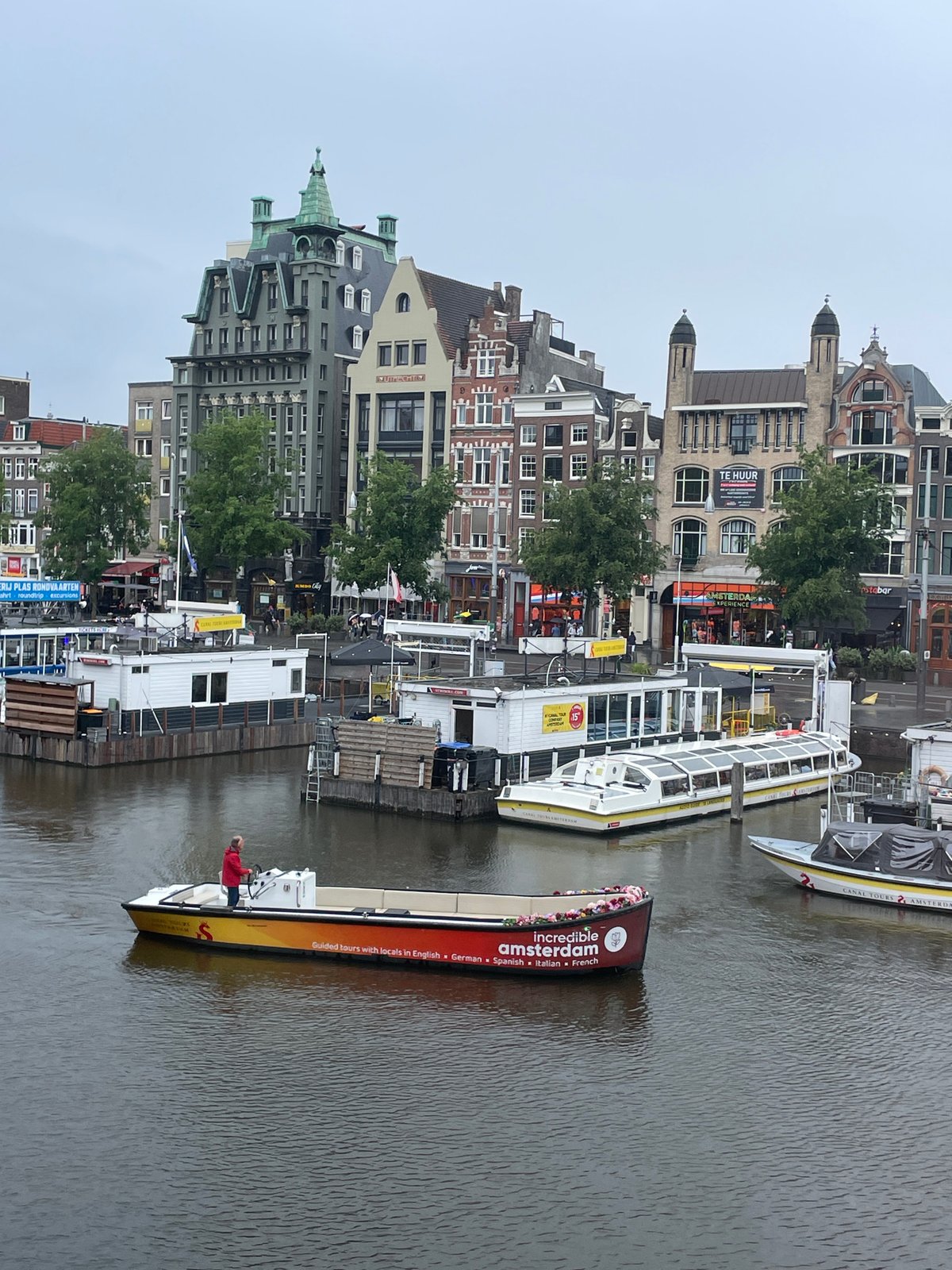 Amsterdam canal scenes documented during overcast afternoon