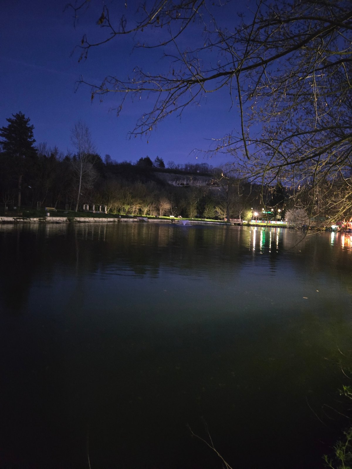 Nighttime scene with water reflections and starlit sky observed
