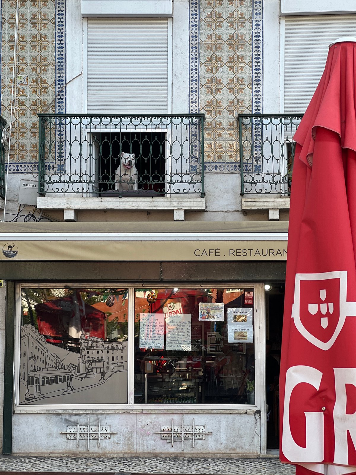 Red-awninged café front on a Lisbon street