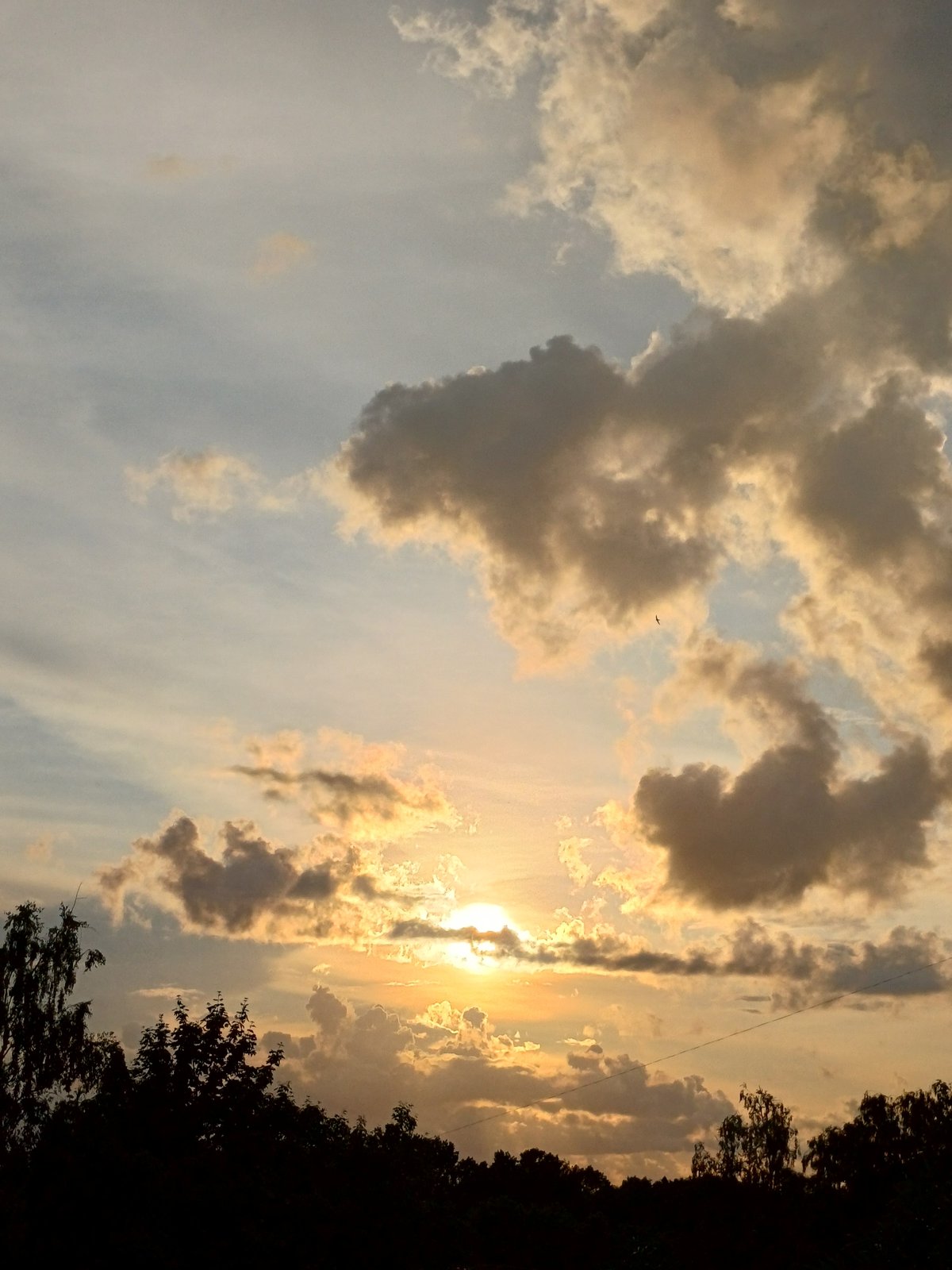 Dramatic cloud-broken sunset over Riga's outskirts
