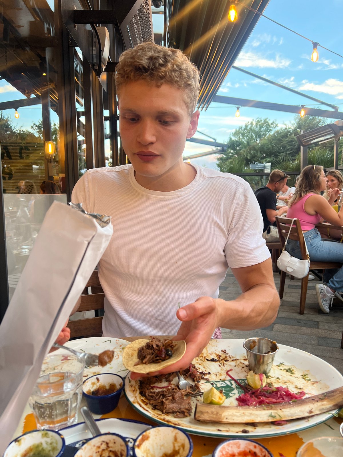 Taco in hand at a London outdoor dining spot
