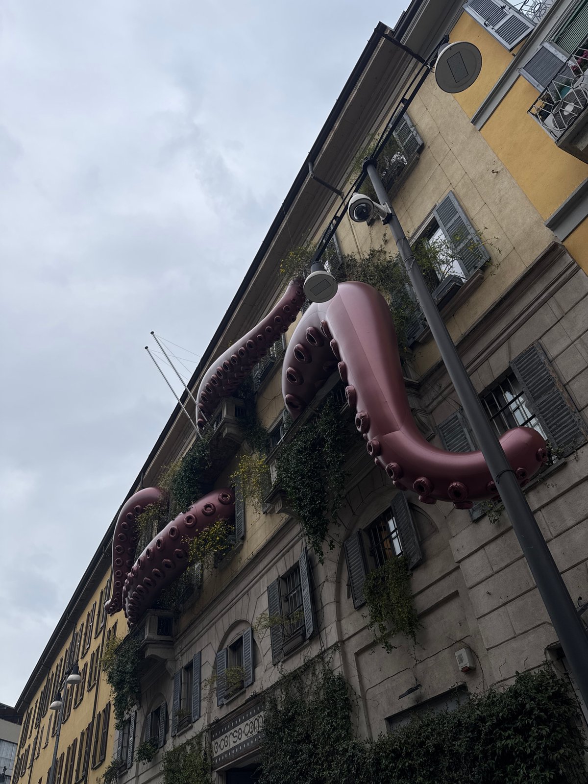 Milan building adorned with inflatable octopus tentacles from windows