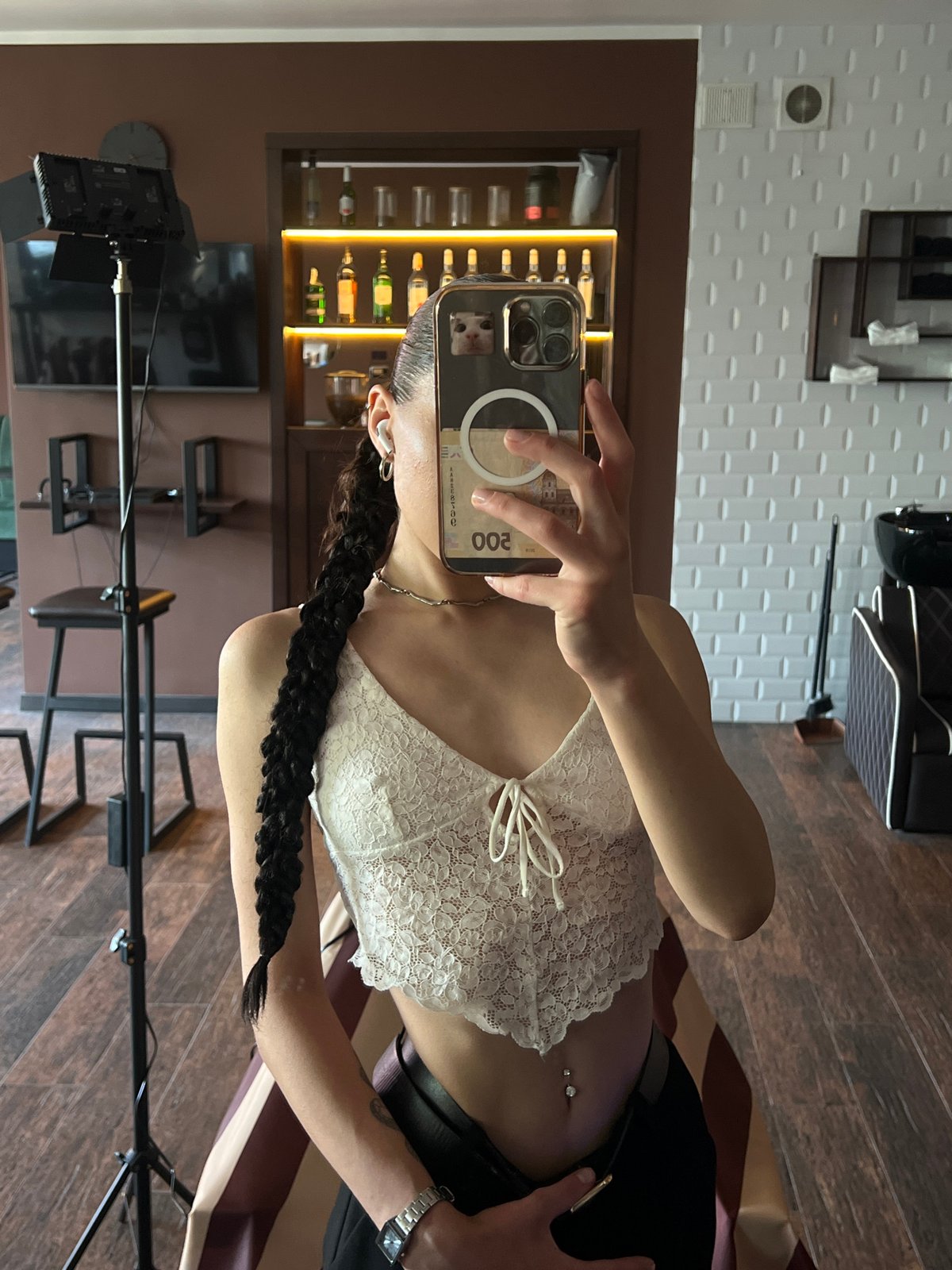 Mirror selfie at a Ternopil salon, white lace top and dark braid.
