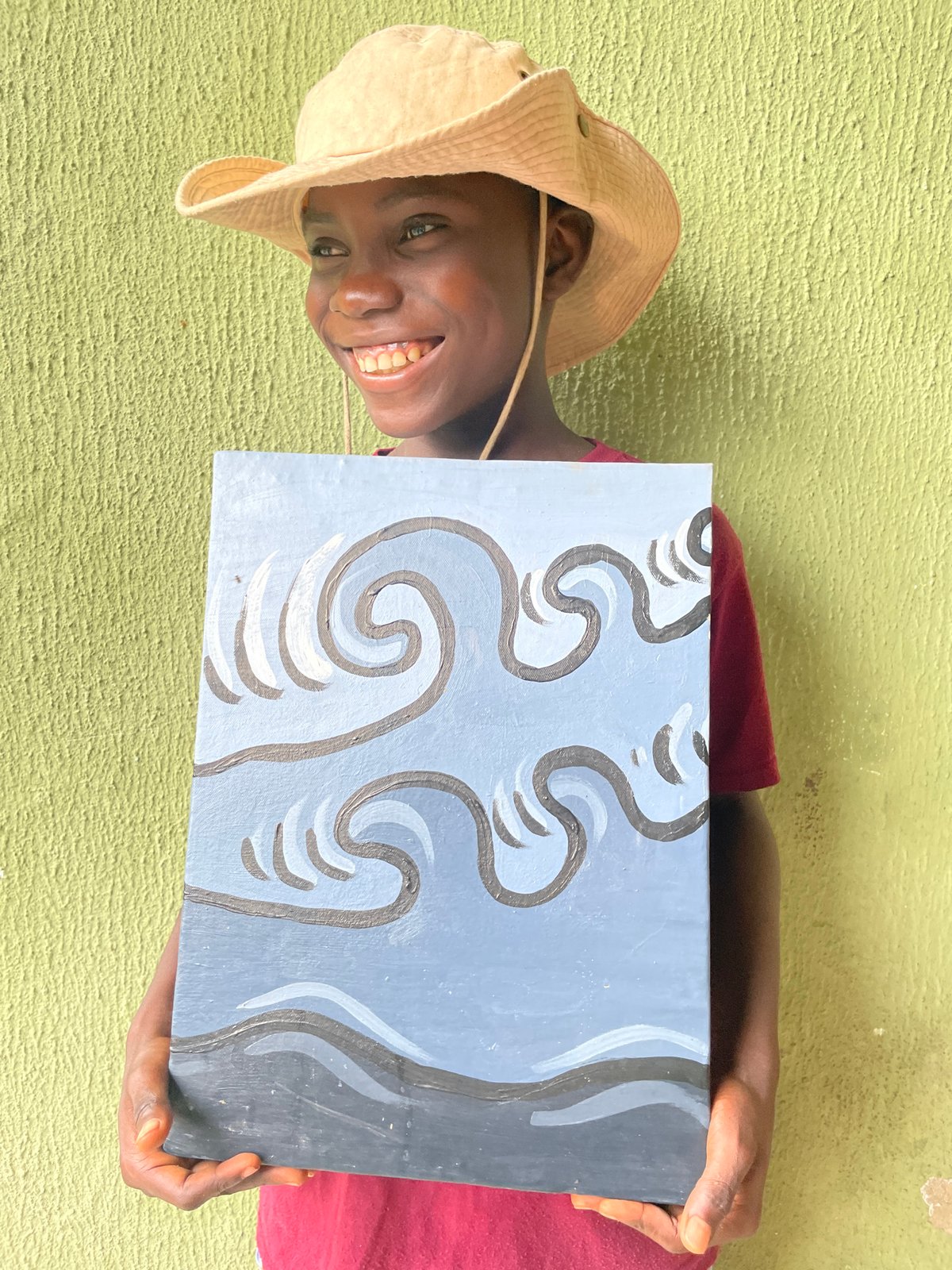 Young artist displays wave paintings on Ado street