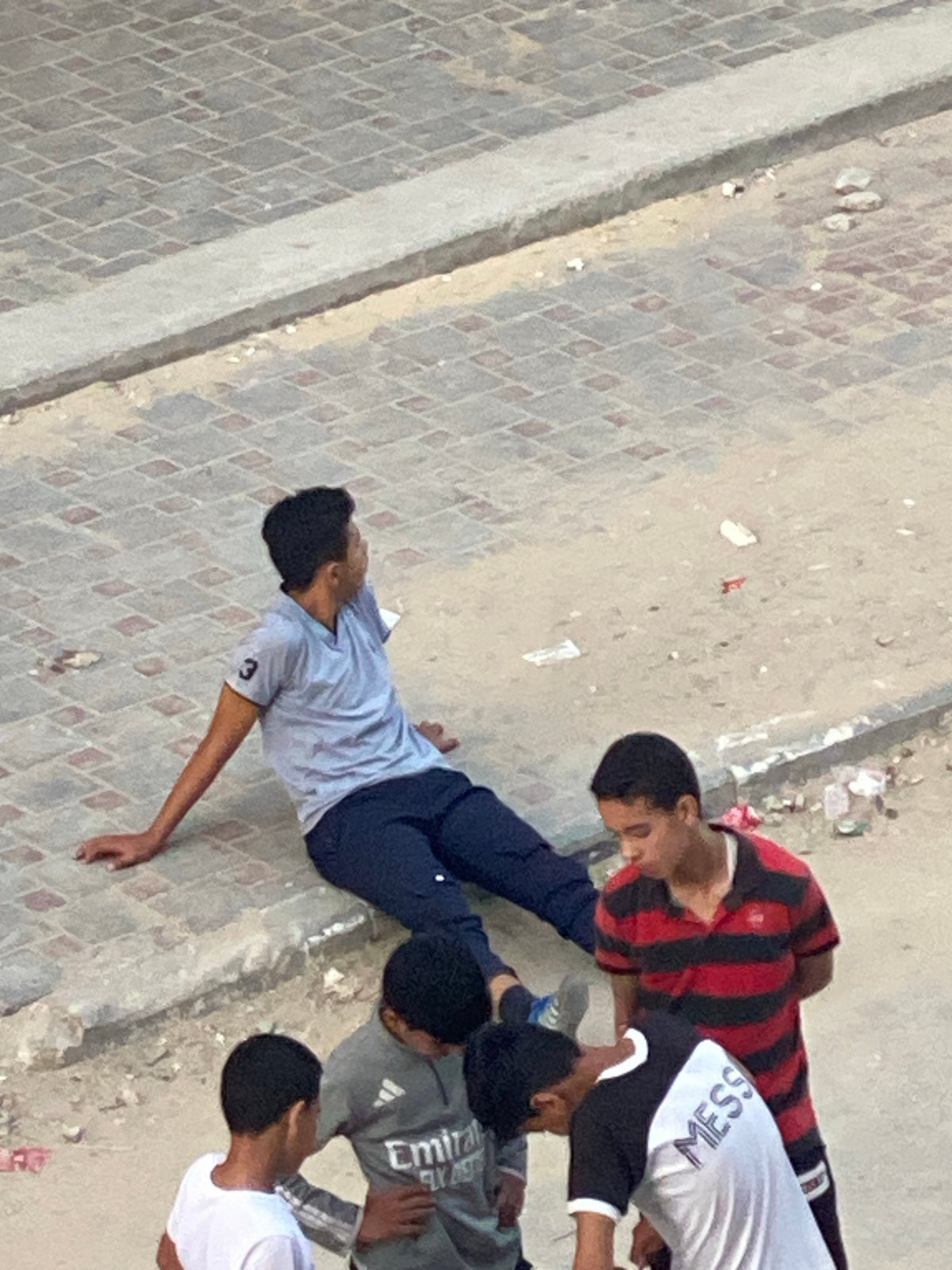 Children play amid damaged buildings and refugee camps in Khan Yunis