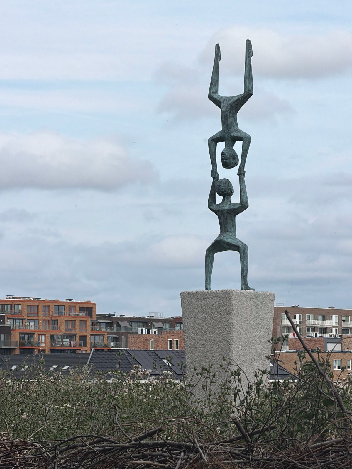 Sculptures and a wooden dock along Rijswijk waterfront