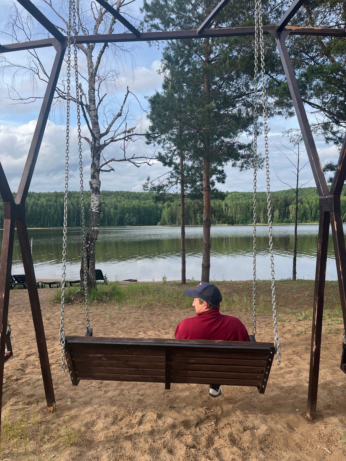 Lakeside gathering with swing, cake, cloudy skies documented