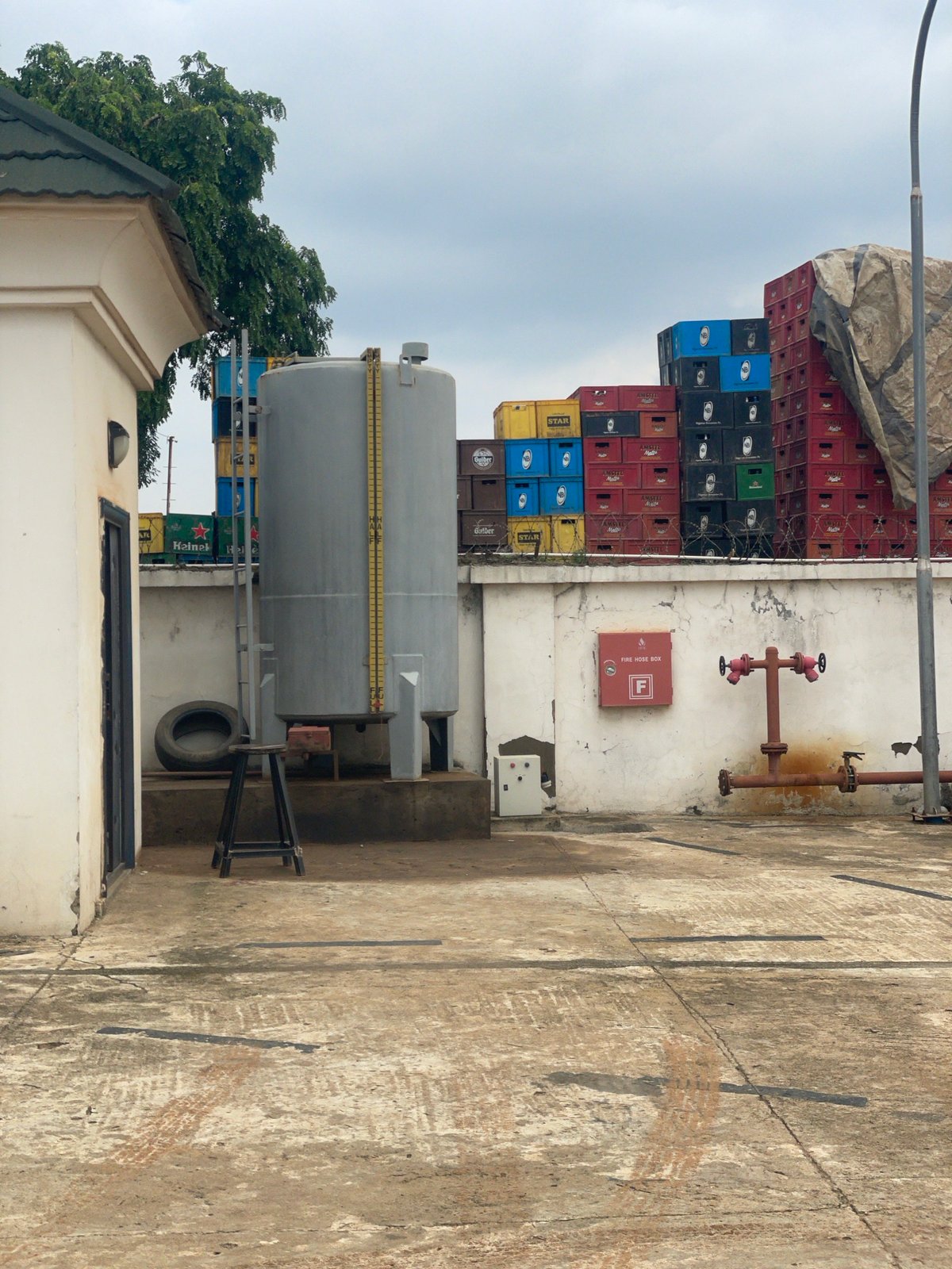 Street-level snapshots from Abuja: vehicles, construction, and a gas cylinder