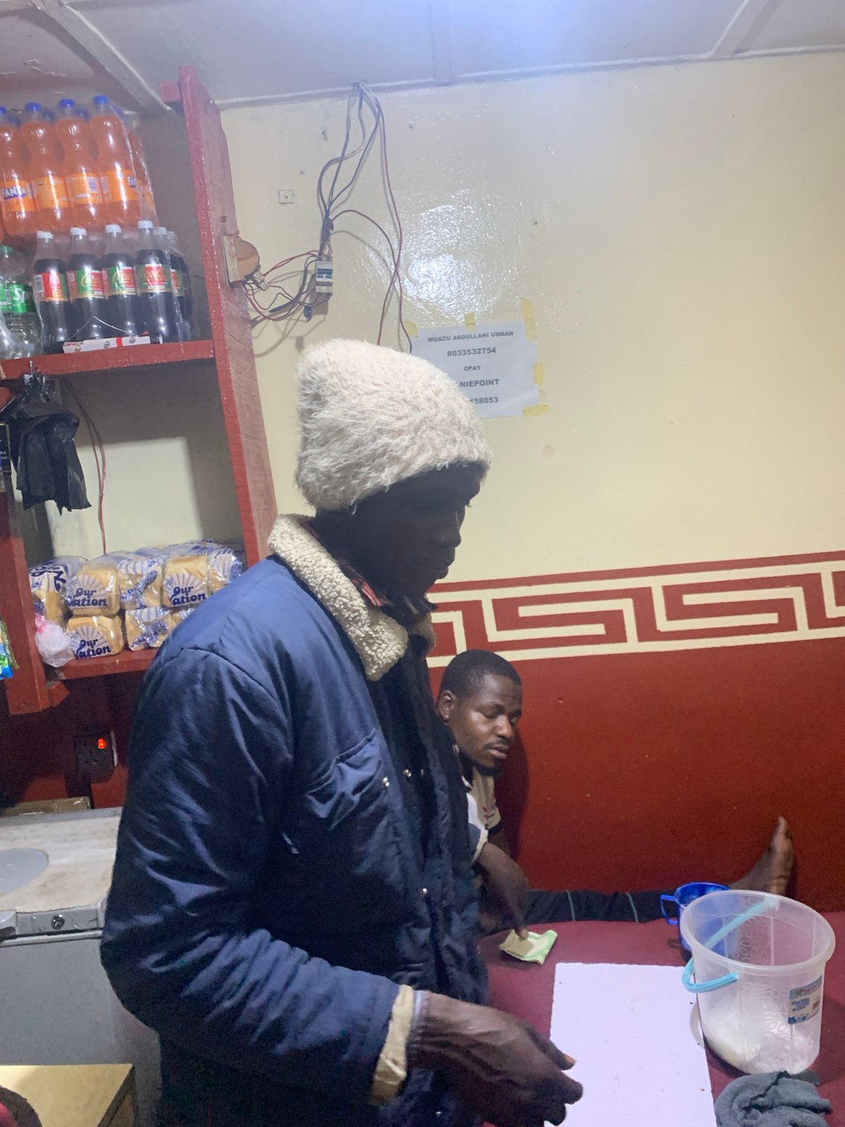 Late-night street life around a Gura Top food stall, Nigeria