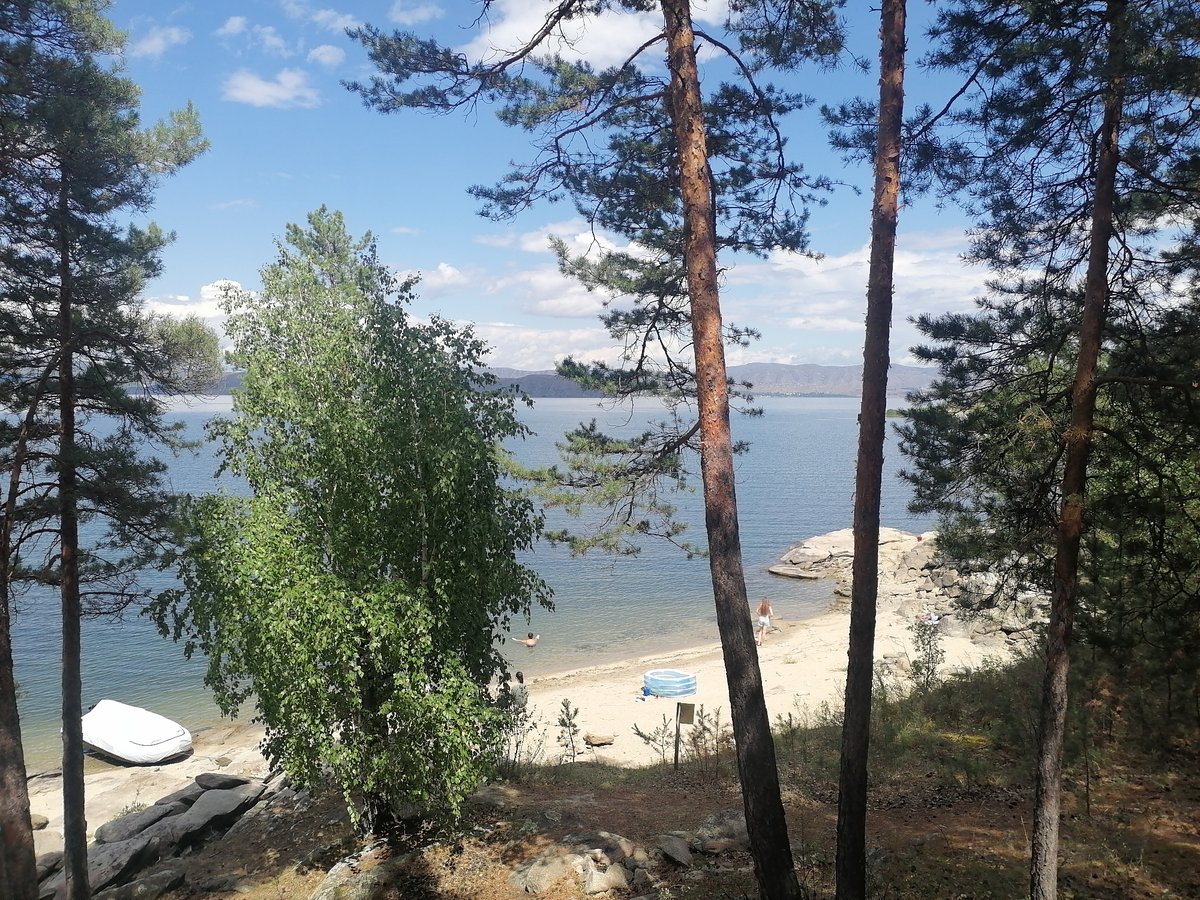 Kayaks and calm water at a Kazakhstan lakeside