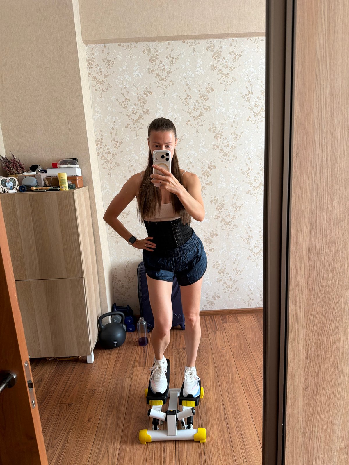 Mirror selfie on a mini stepper in a Riga home gym