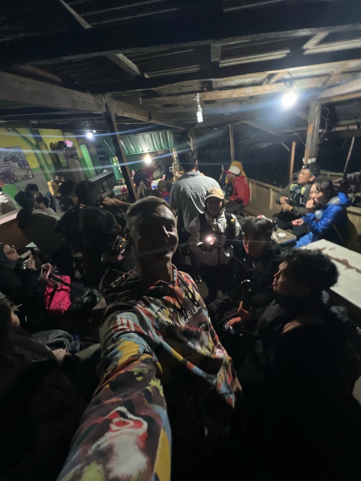 Evening gathering in basic shelter documented in Indonesia
