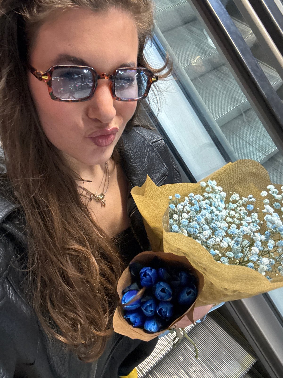 Woman with flower bouquets spotted lying on Madrid escalator