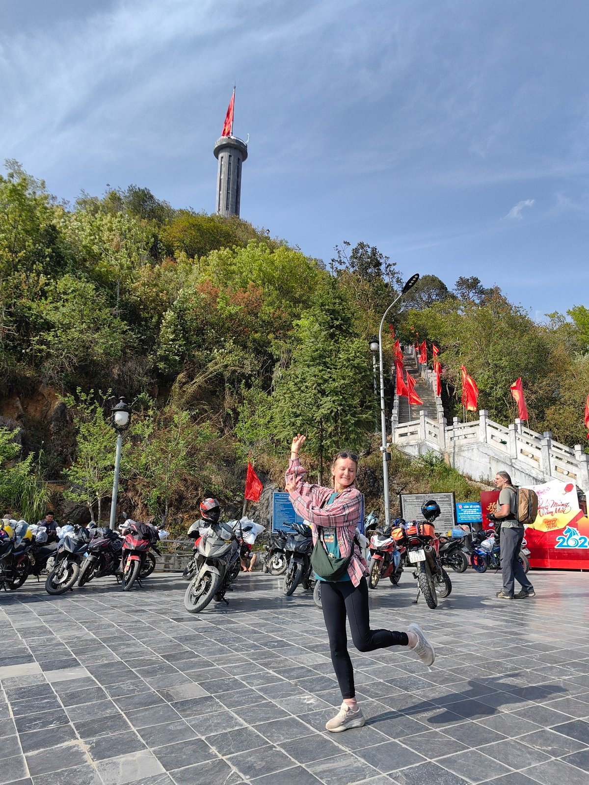 Woman poses for photo in Vietnamese commune square