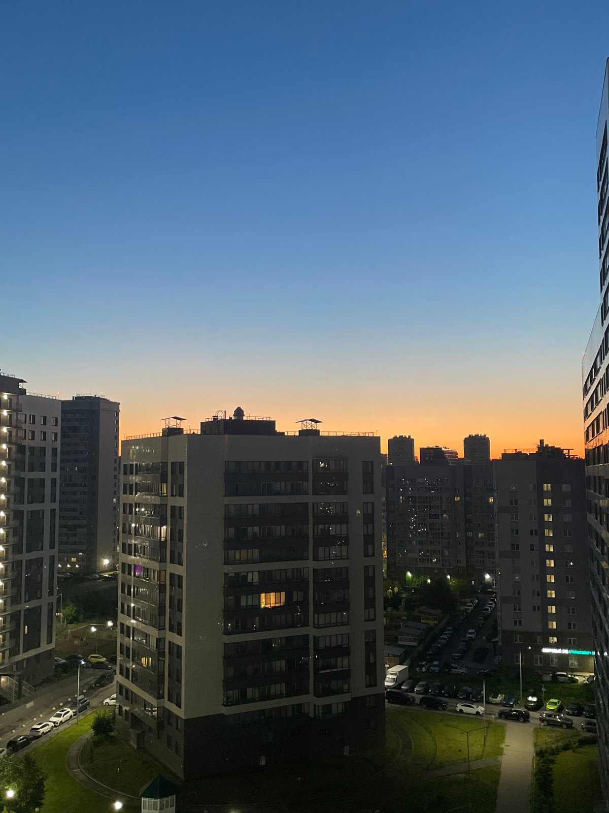 Twilight over Sinyavino's residential blocks, coffee in hand