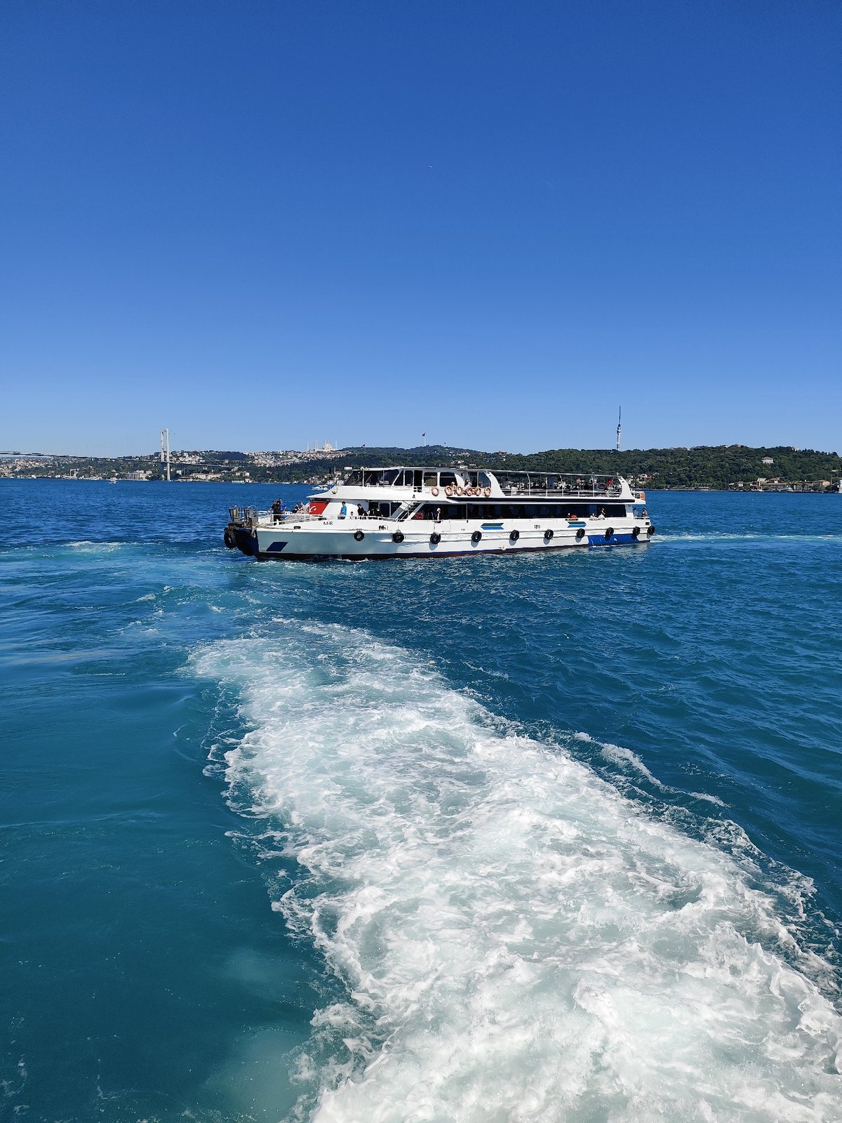 Ferry traffic flows across Bosphorus during sunny Istanbul afternoon