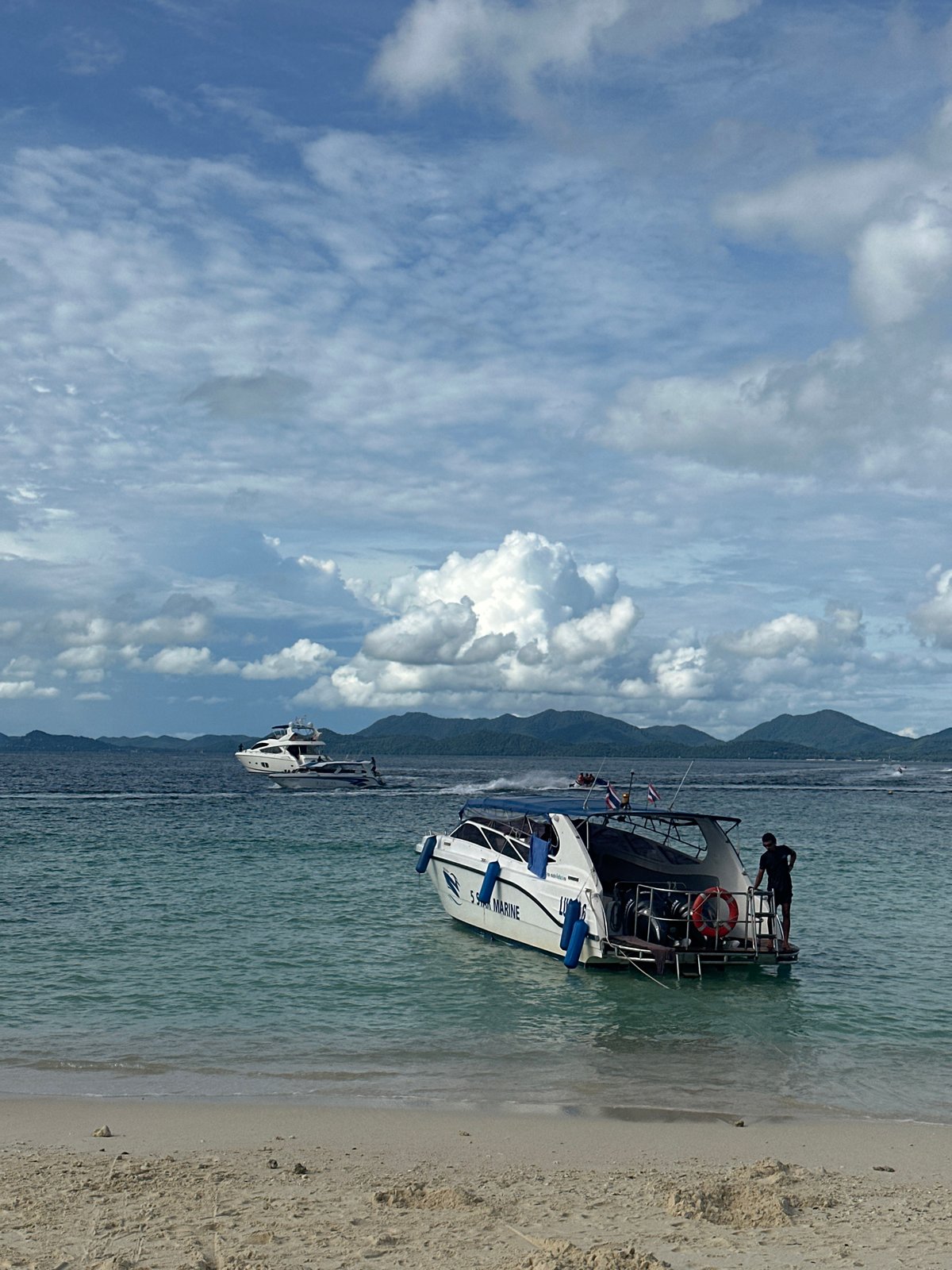 Busy morning at a Phru Nai beach, boats and Jetski Club umbrellas