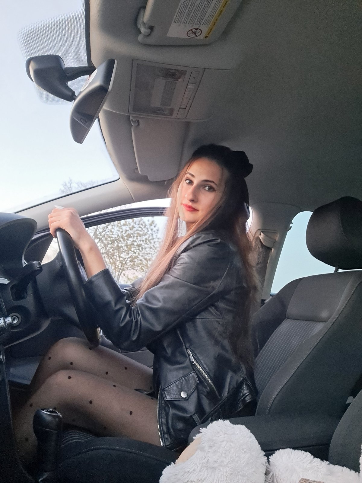 Woman photographs herself in car in Lokorsko, Bulgaria