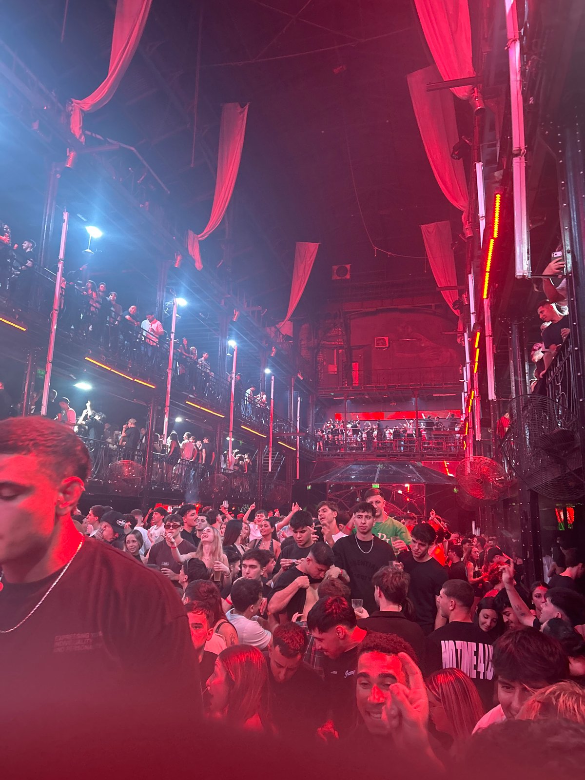 Indoor crowd gathers at red-lit event in Buenos Aires