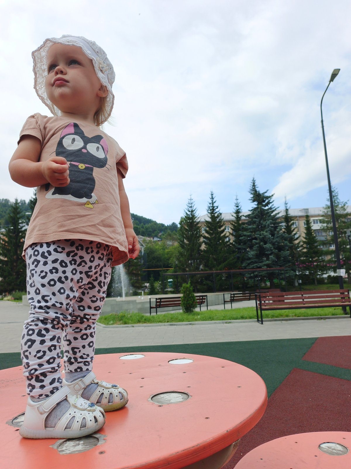 Summer morning at Zlatoust's public plaza, fountains and play structures