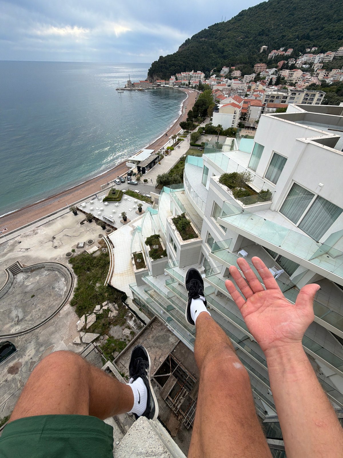 Person observed on rooftop overlooking Montenegro coastal town