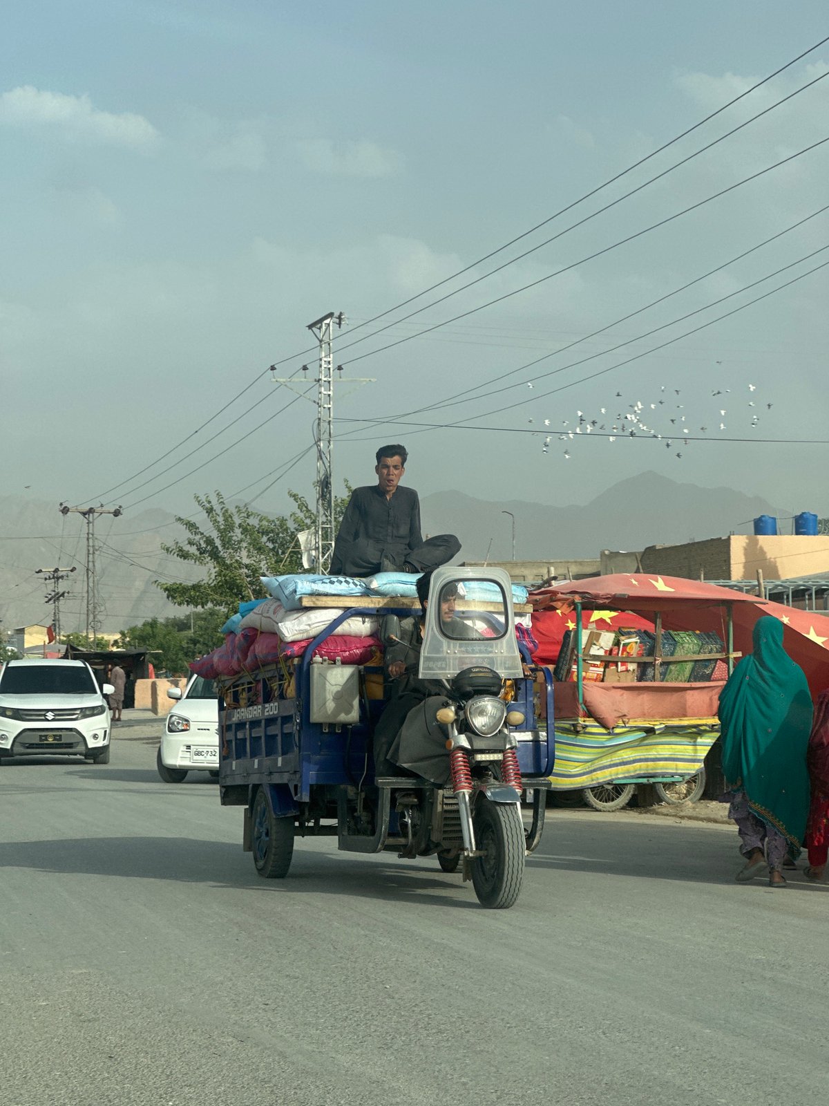 Commercial three-wheeler transports goods through Quetta streets