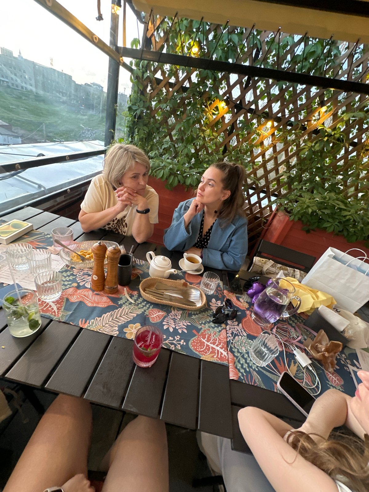 Diners enjoy drinks at outdoor restaurant terrace in Perm