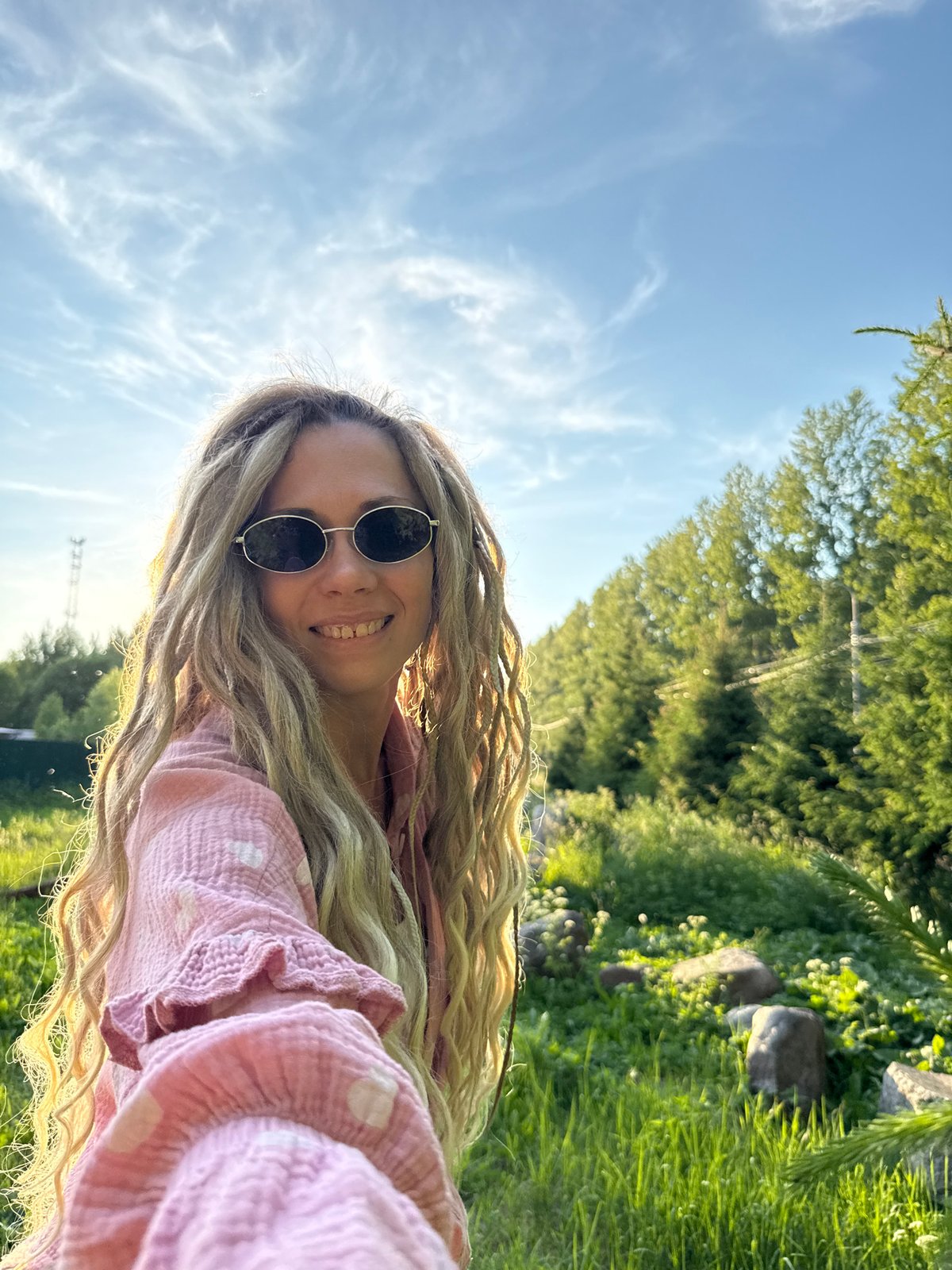Woman photographs golden hour selfies along Russian railway tracks
