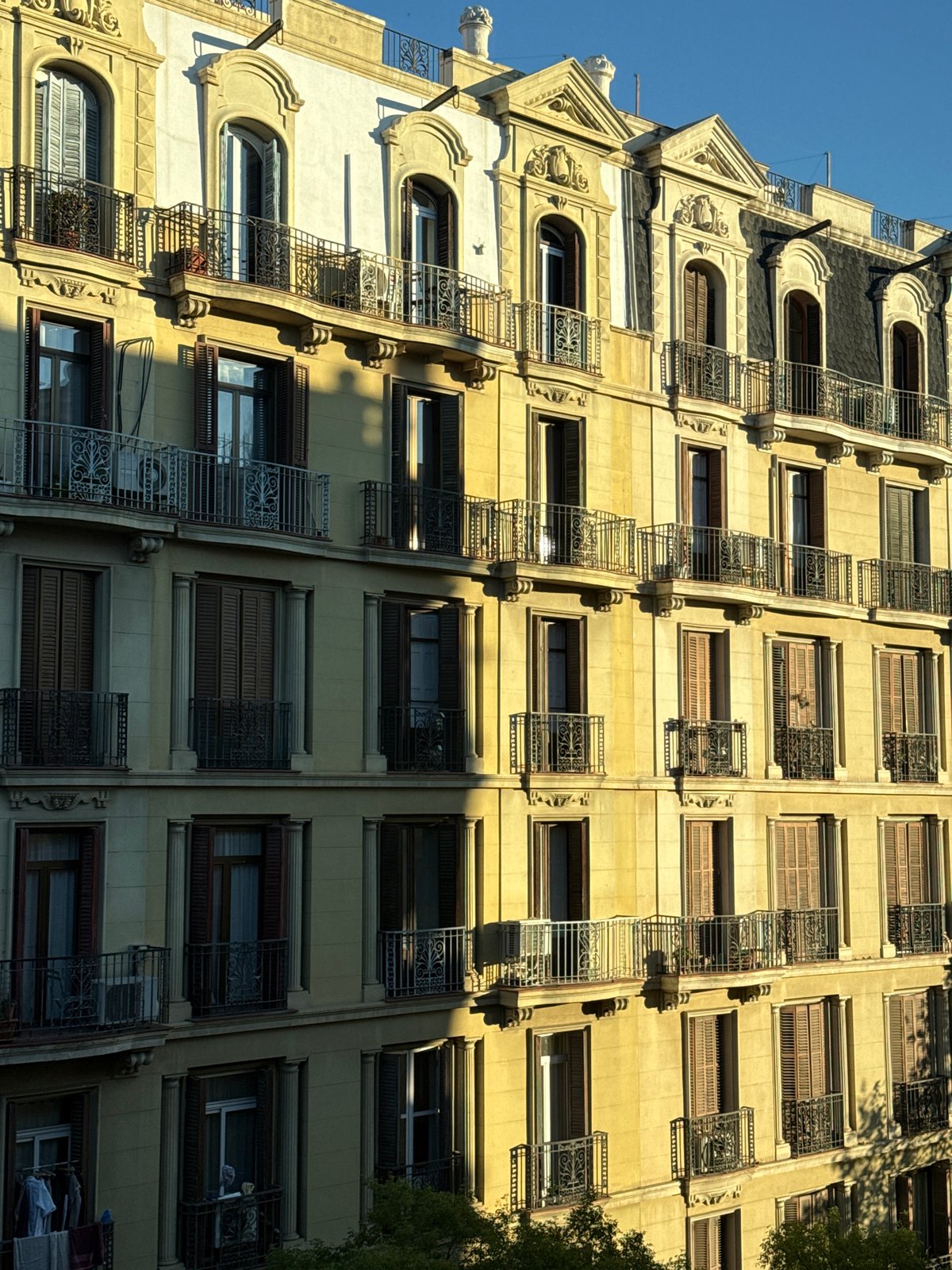 Barcelona building facade with decorative ironwork documented by witness