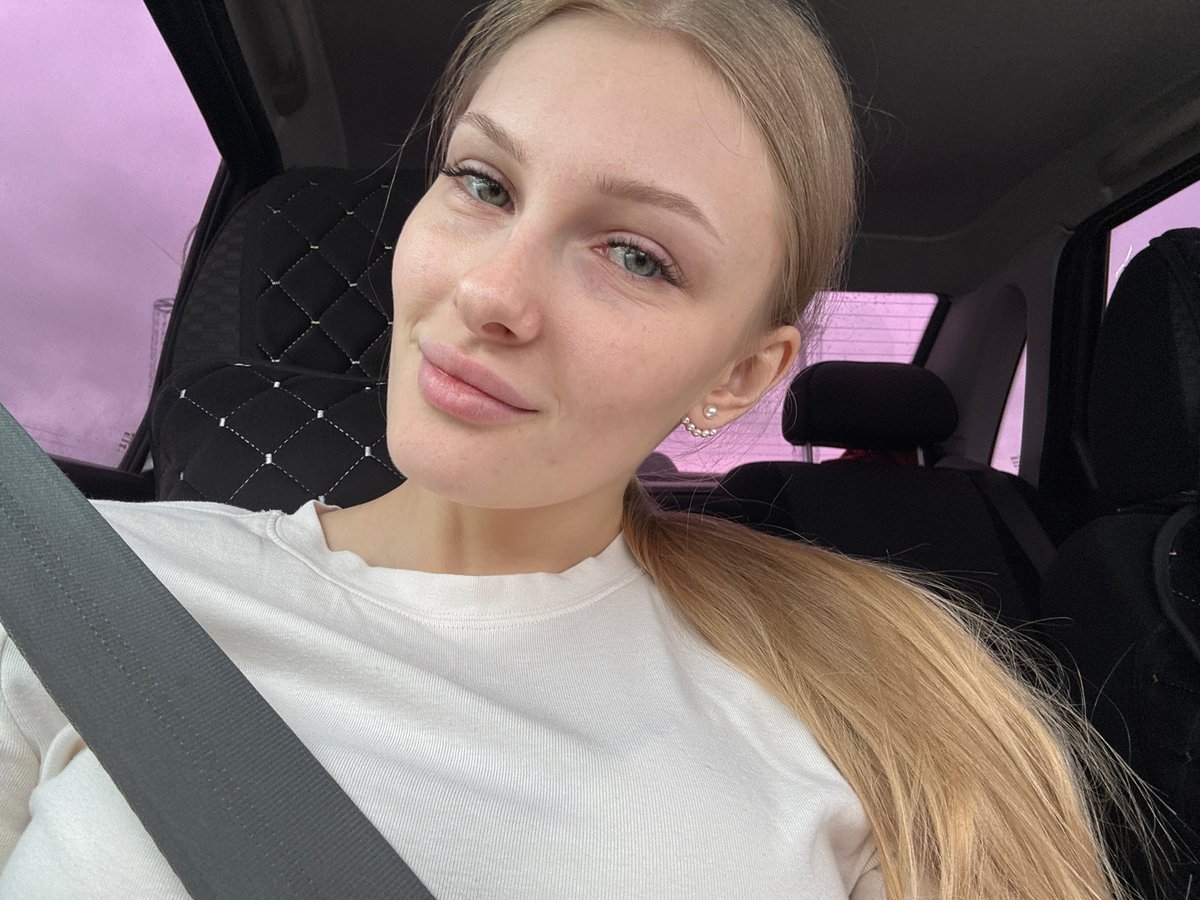 Woman photographed in car during afternoon drive in Perm
