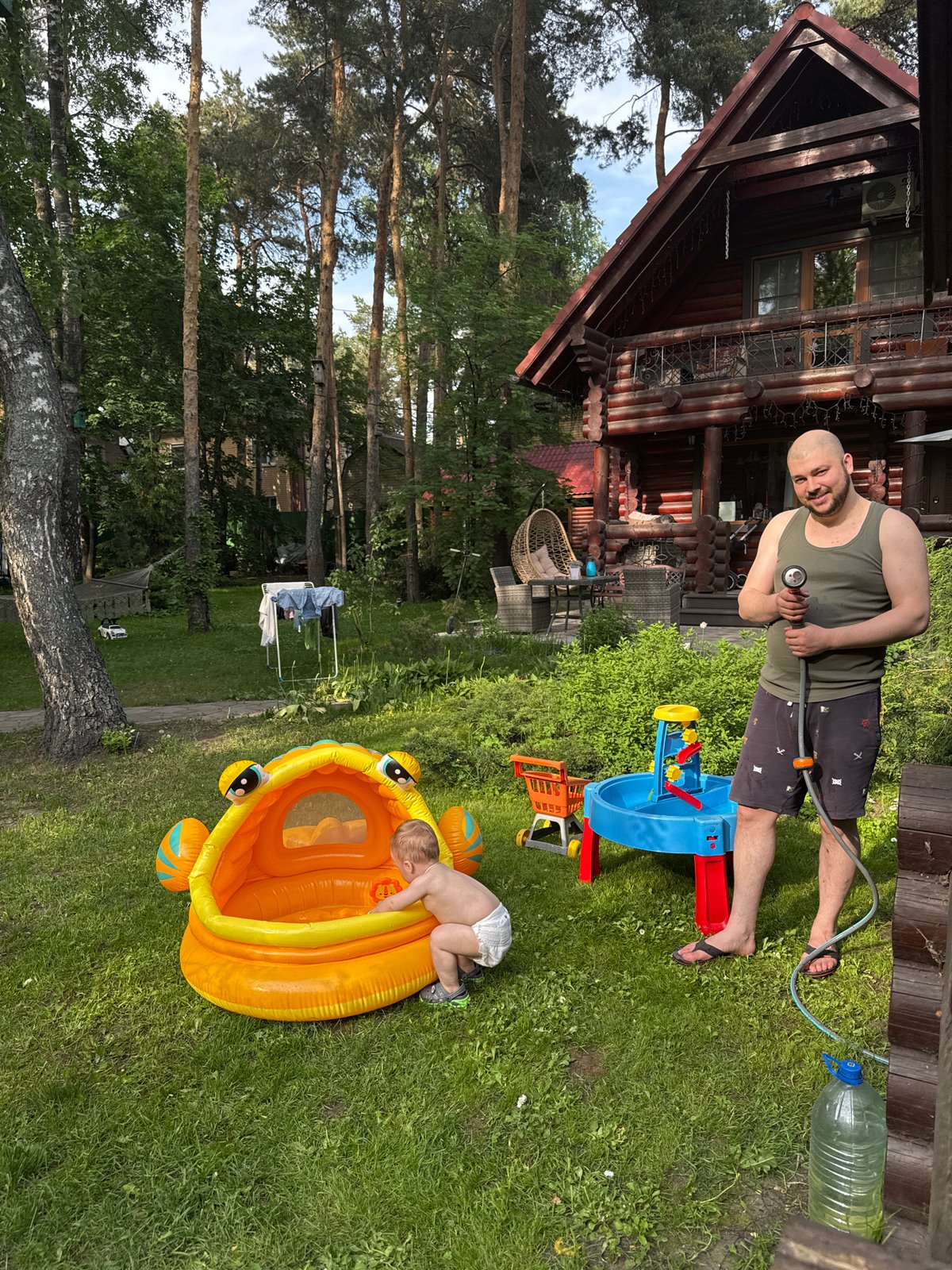 Family enjoys afternoon playtime in backyard pool in Tomilino