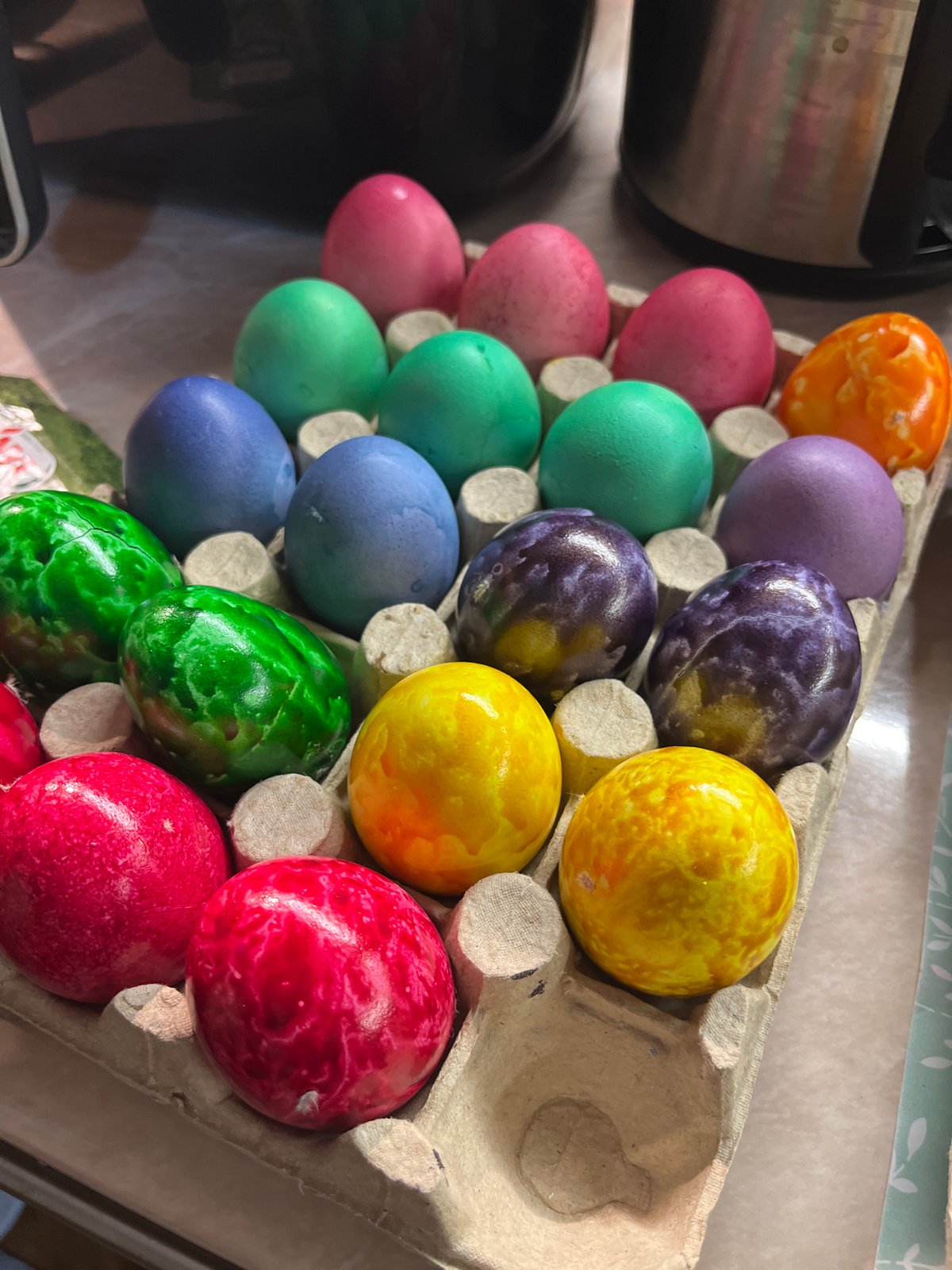Colorful marbled Easter eggs displayed in cardboard carton