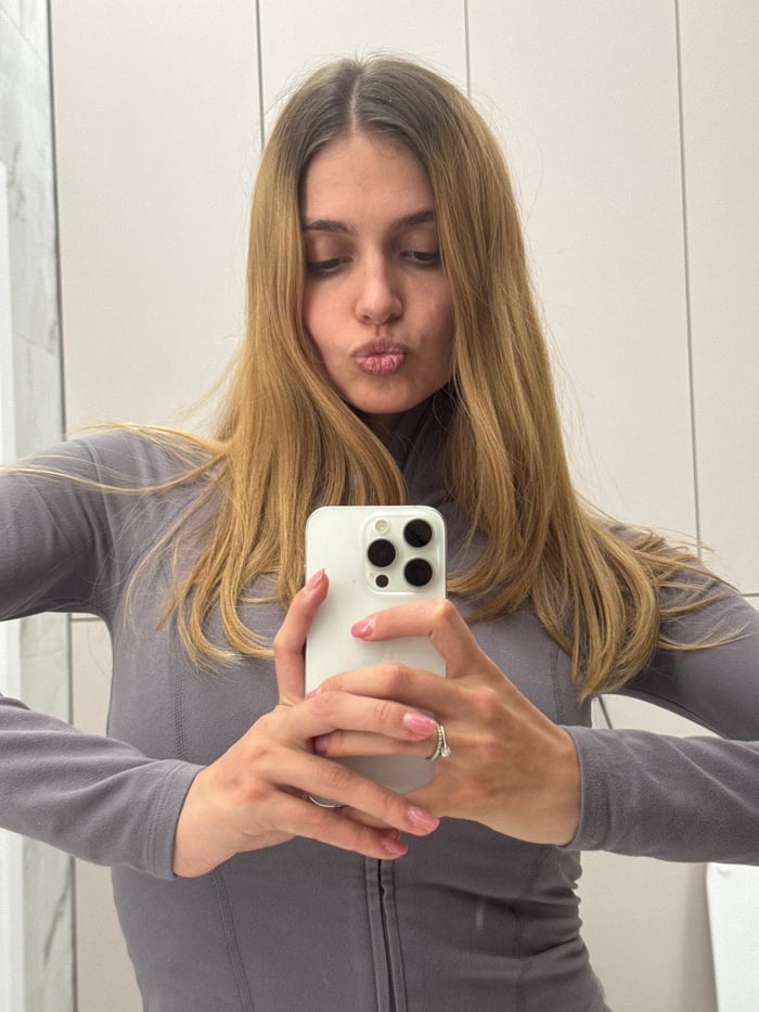 Woman takes bathroom selfies while snacking on prepared meal