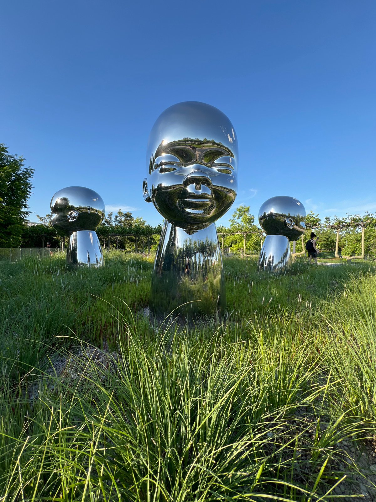 Chrome head sculptures documented in Krasnodar park during sunny afternoon