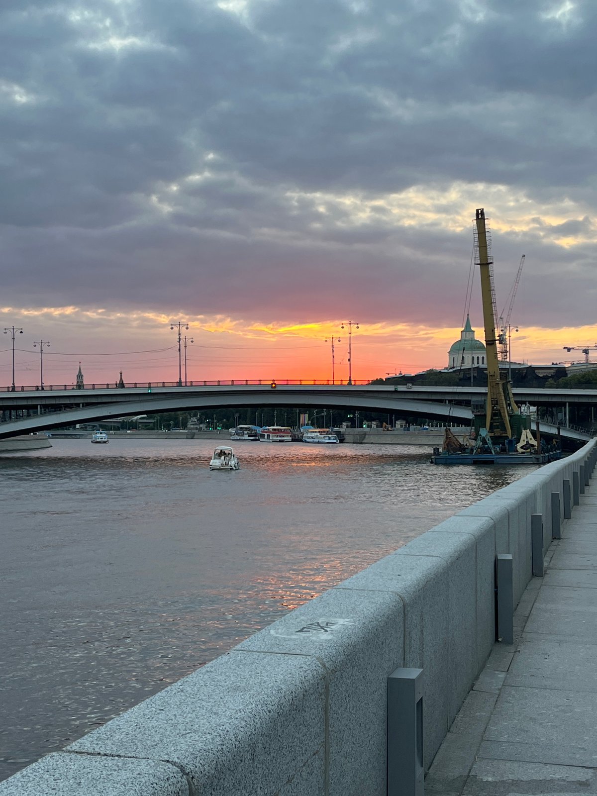 Dusk on the Moskva River, construction barge and bridge at sunset
