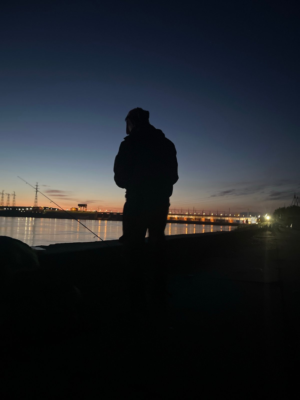 Twilight fishing scene captured in Noviy, Russia