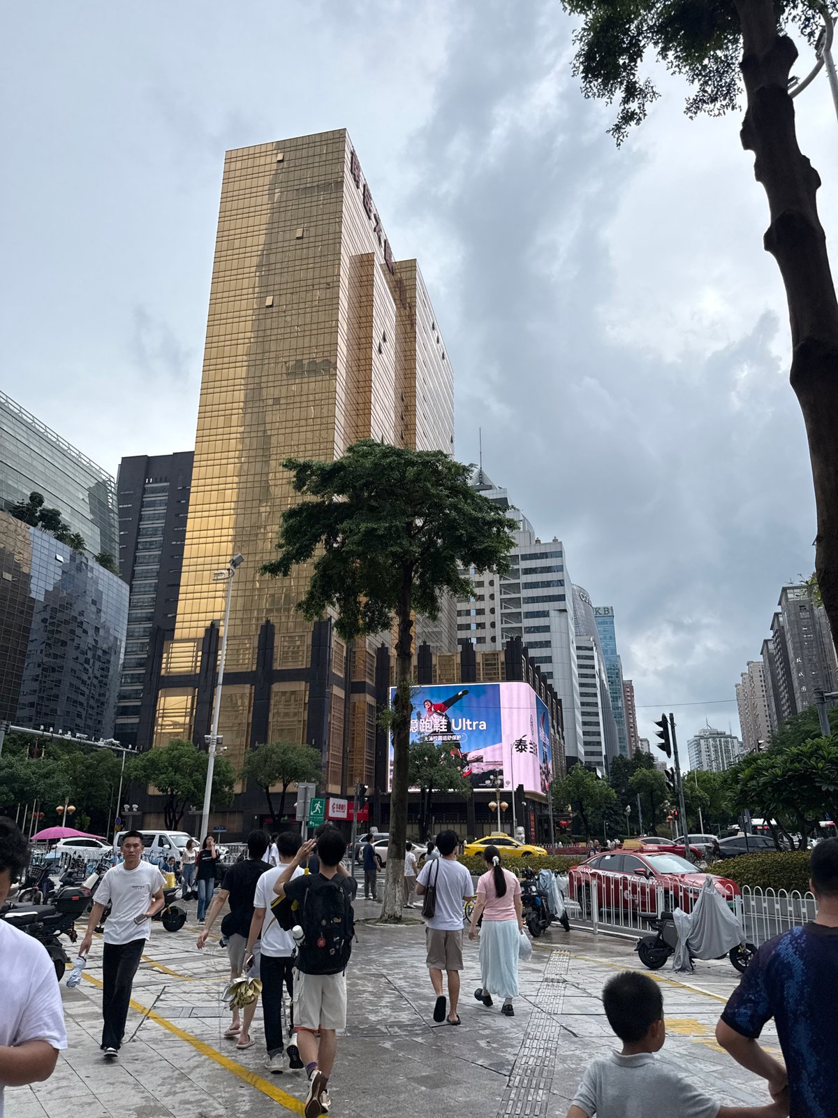 Busy morning streets in Guangzhou's Tianhe District under grey skies