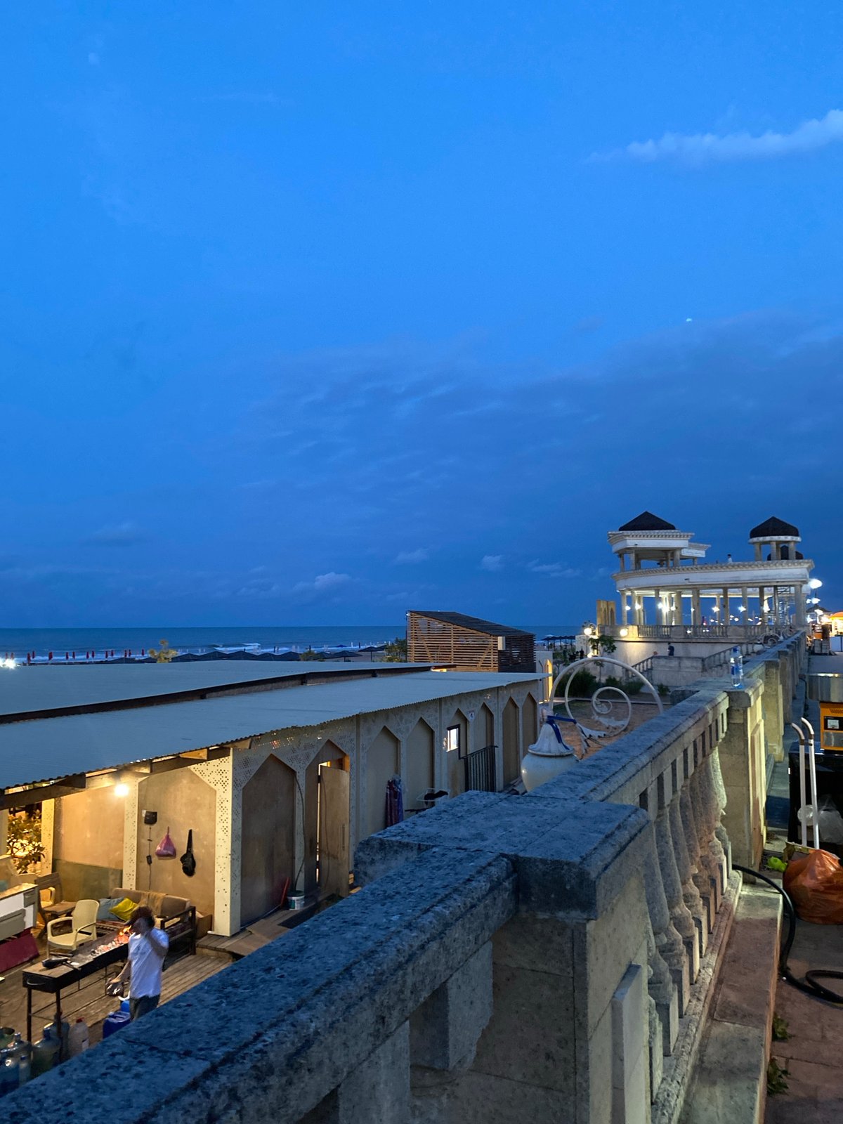 Derbent promenade at dusk: rides, toy cars, Caspian views