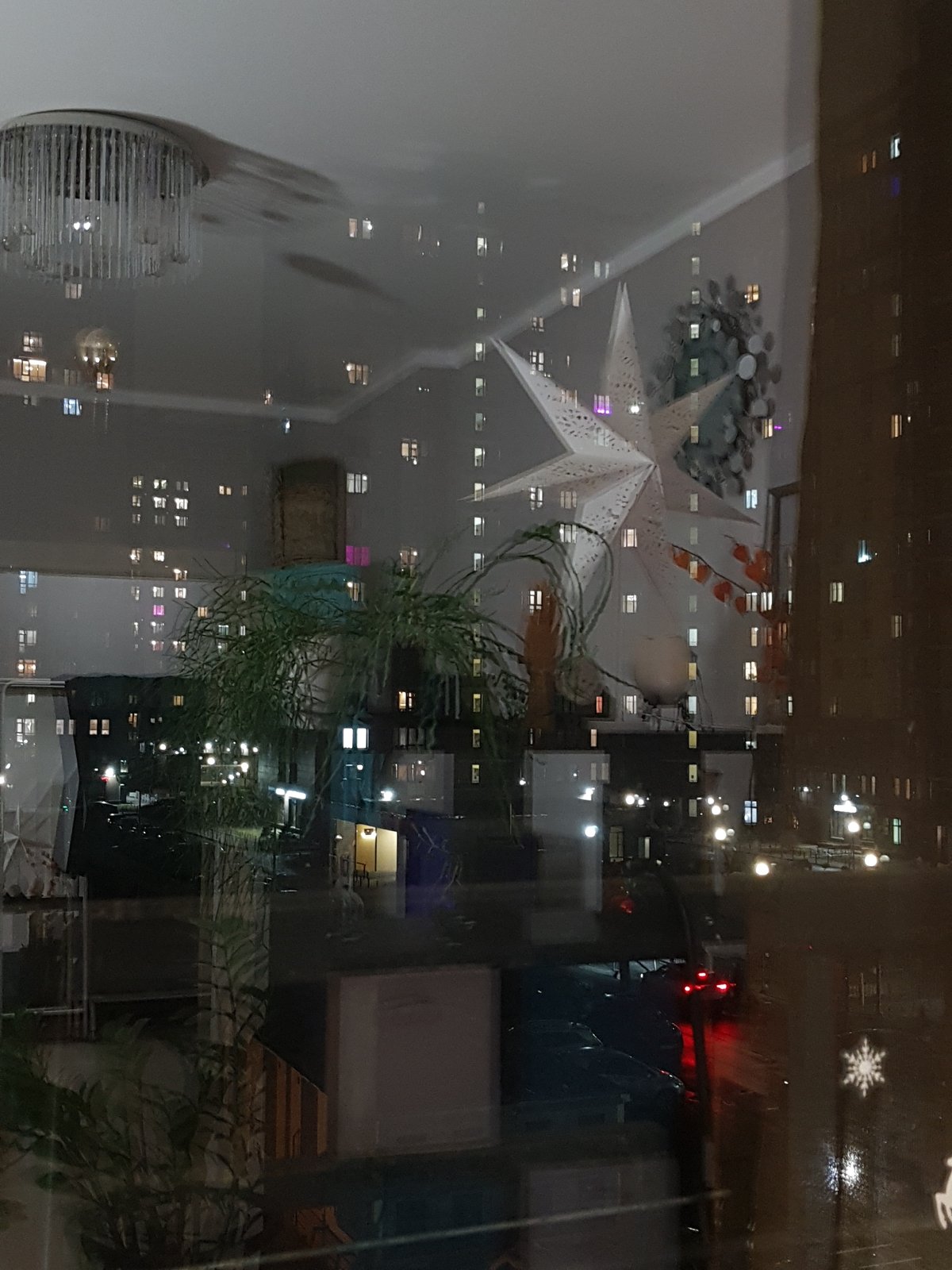 Window reflection captures home interior scene in Saint Petersburg