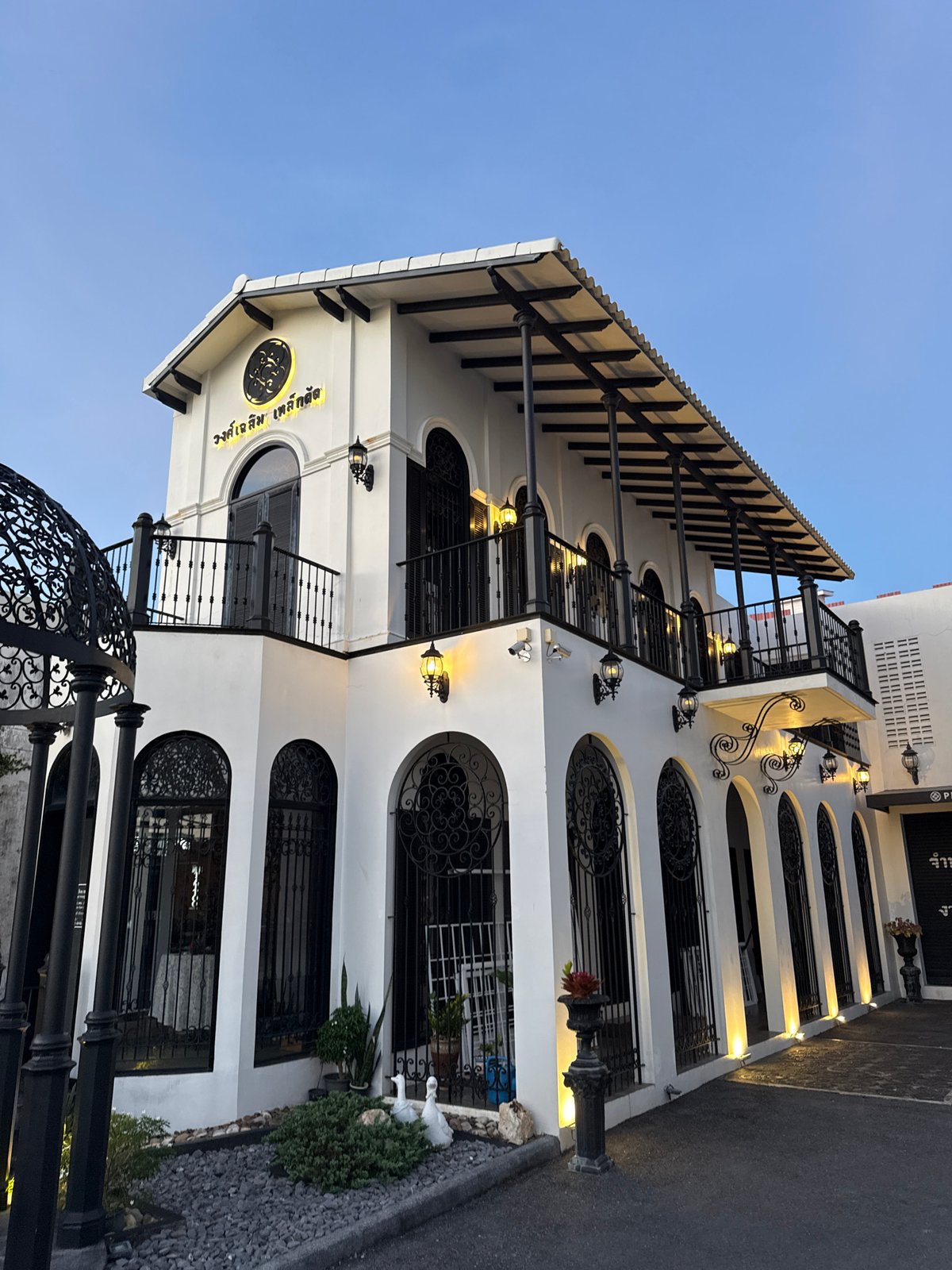 Street-level Phuket: ornate building facade and busy bike parking
