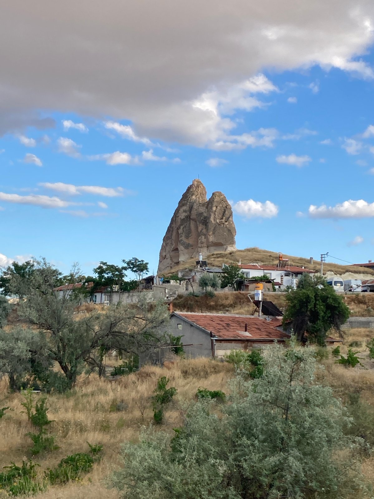 Afternoon scenes from Avanos: farmland, rocky horizons, and a curious cat
