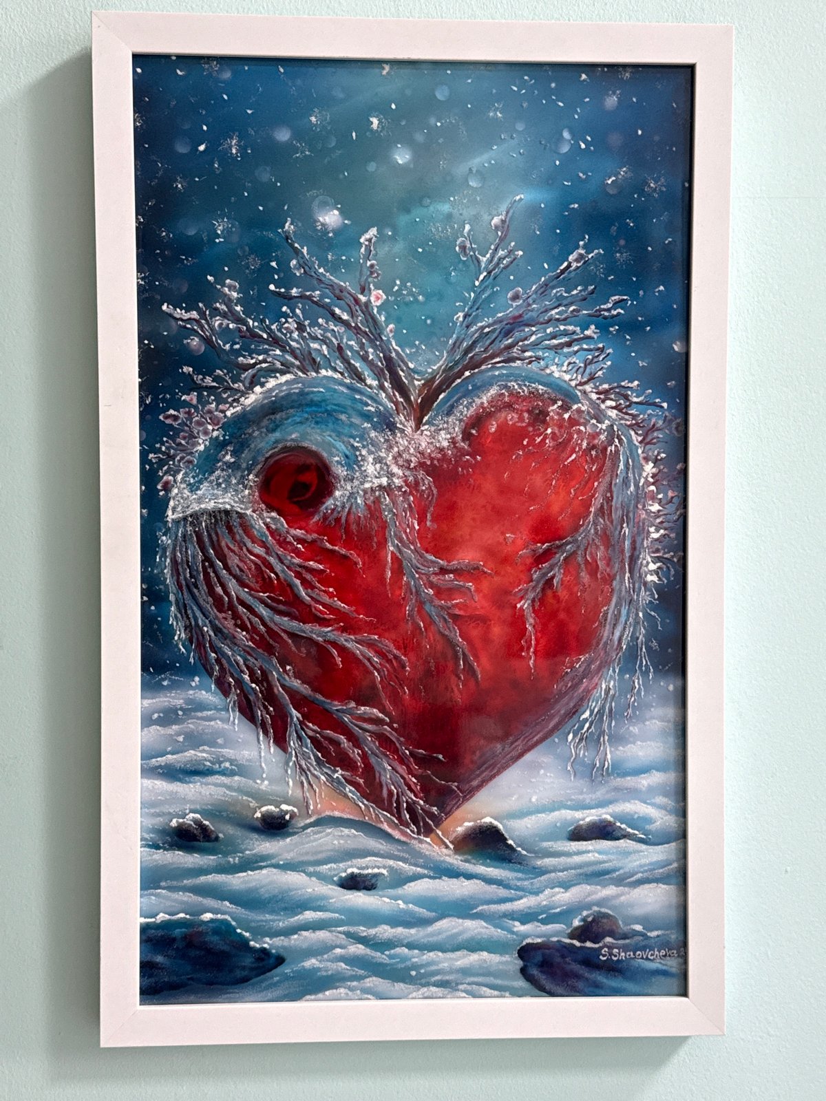 Art display with heart painting and nail competition trophy observed